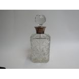 A Charles S Green & Co Ltd crystal glass silver necked decanter with facet finial stopper slight