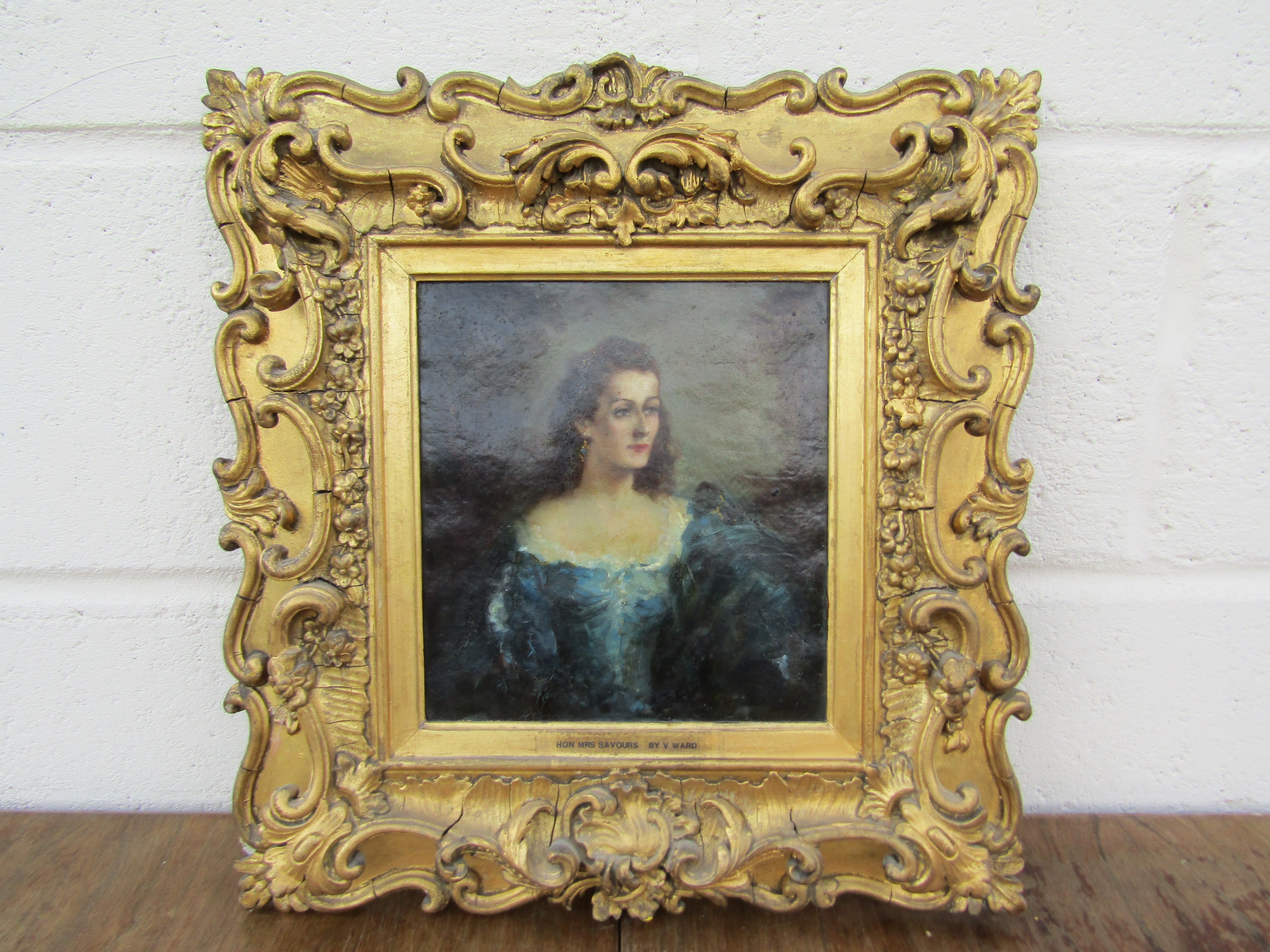 An oil on paper depicting Hon Mrs Savours by V Ward, ornate gilt frame,