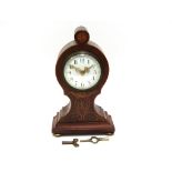 An Edwardian mahogany and brass/satin inlaid balloon form timepiece.