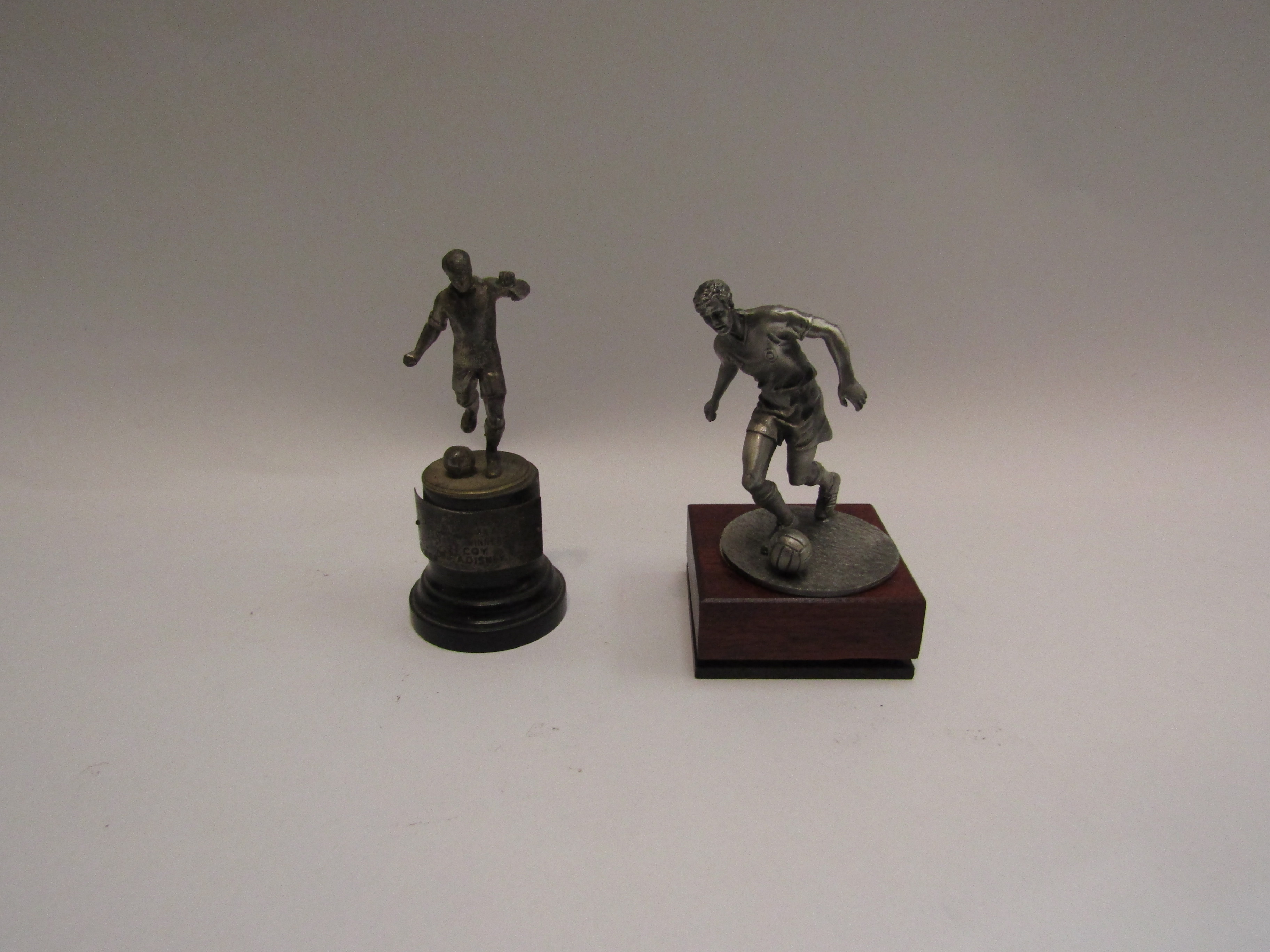 Two football figure trophies,