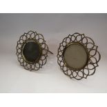 A pair of circular wrought brass easel backed picture frames