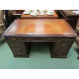 A George III style mahogany twin pedestal desk of eight drawers on a plinth base,