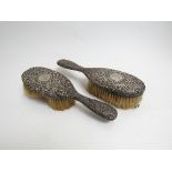 A pair of Victorian silver backed dressing table brushes, deep scrolled relief,