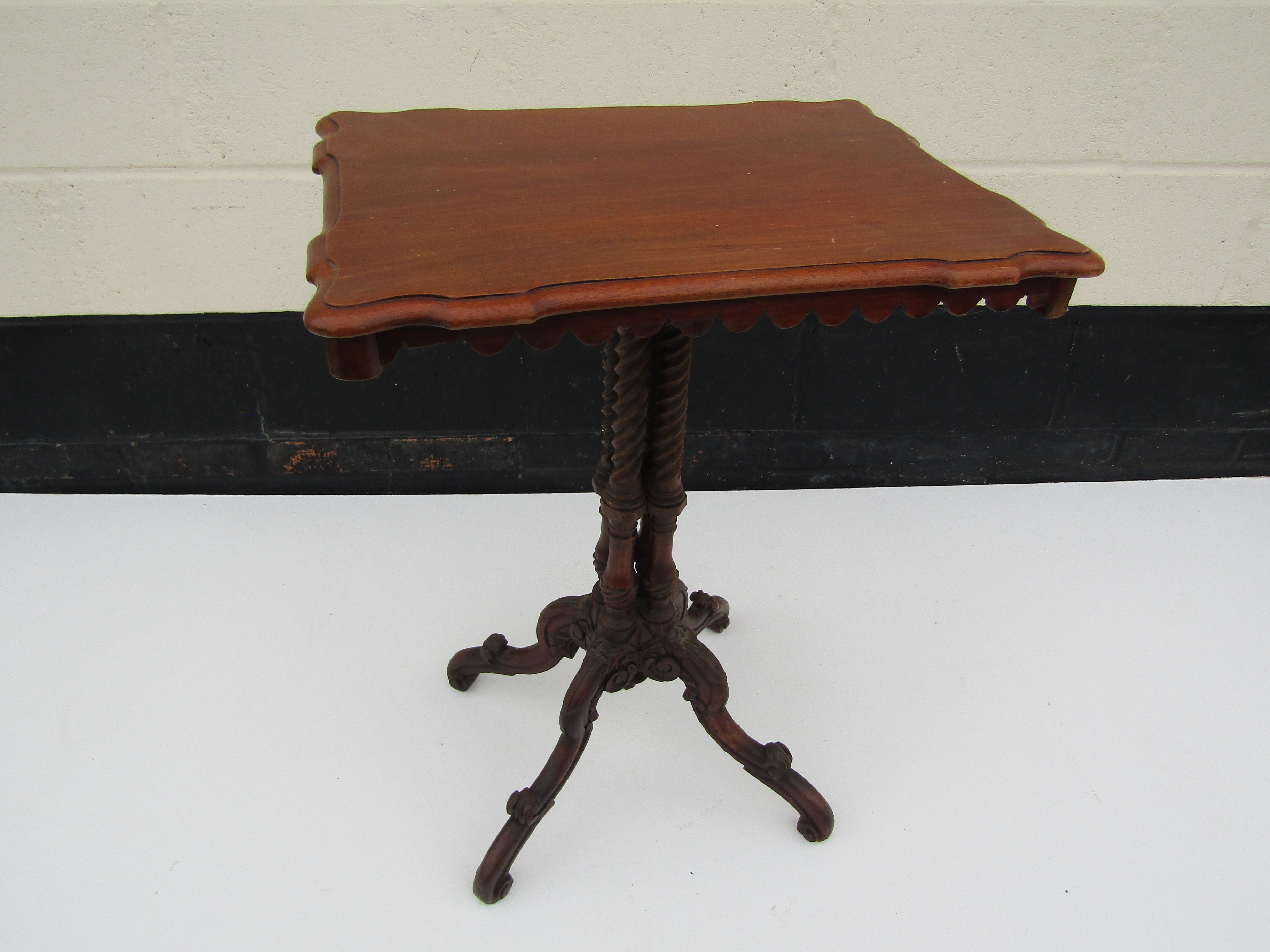 An Edwardian mahogany rectangular topped occasional table with four wrythen column support to