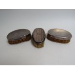 Three silver backed brushes, shoe horn,