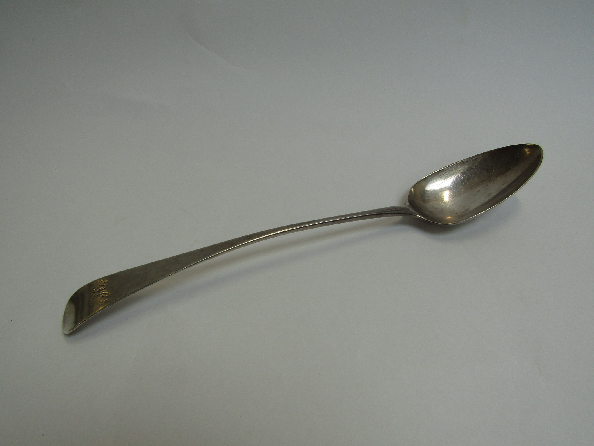 A Samuel Godbehoe and Edward Wigon silver basting/stuffing spoon, London 1799, monogrammed H,