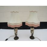 A pair of ceramic Art Nouveau lamps with floral decoration and tasselled shades,