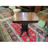 A Victorian round cornered top lamp table on a carved base and outswept legs,