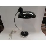 A modern adjustable desk lamp with black enamel shade,