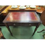 A mid Victorian oak writing desk the tooled leather inset over a single frieze drawer with working