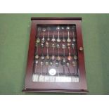 A display case containing a collection of souvenir spoons