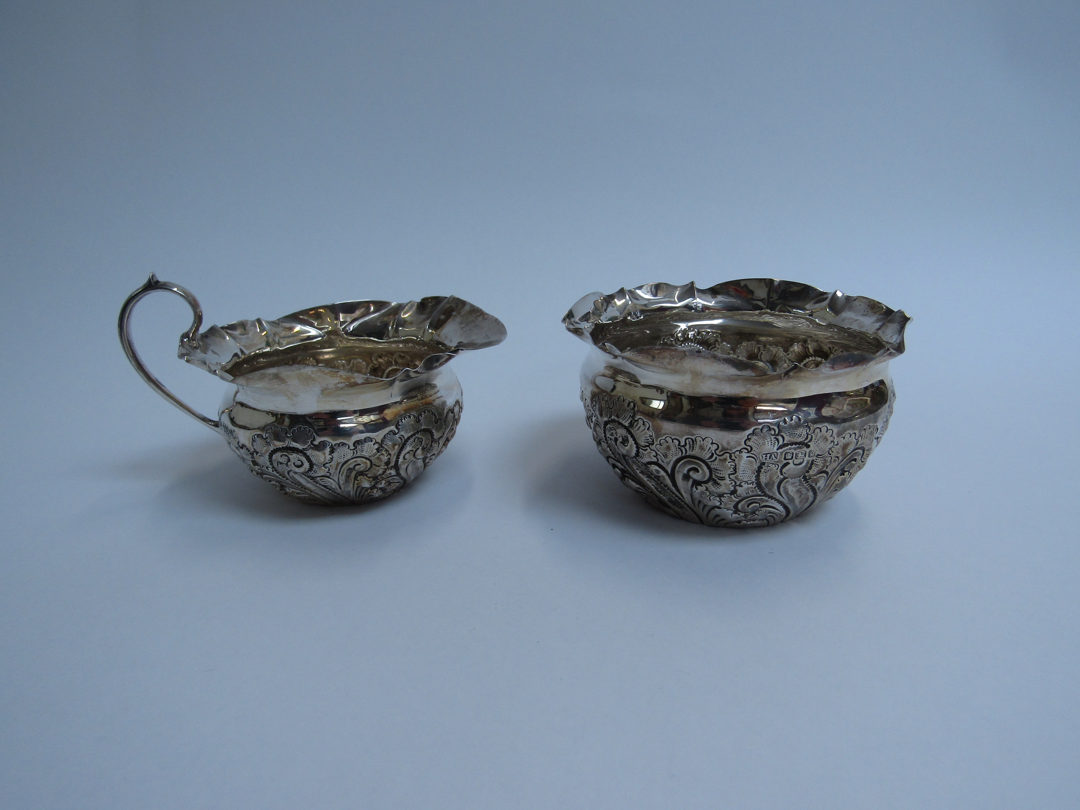 Atkin brothers silver embossed cream jug and sugar bowl Sheffield 1900 (2) 147g (split to lip of