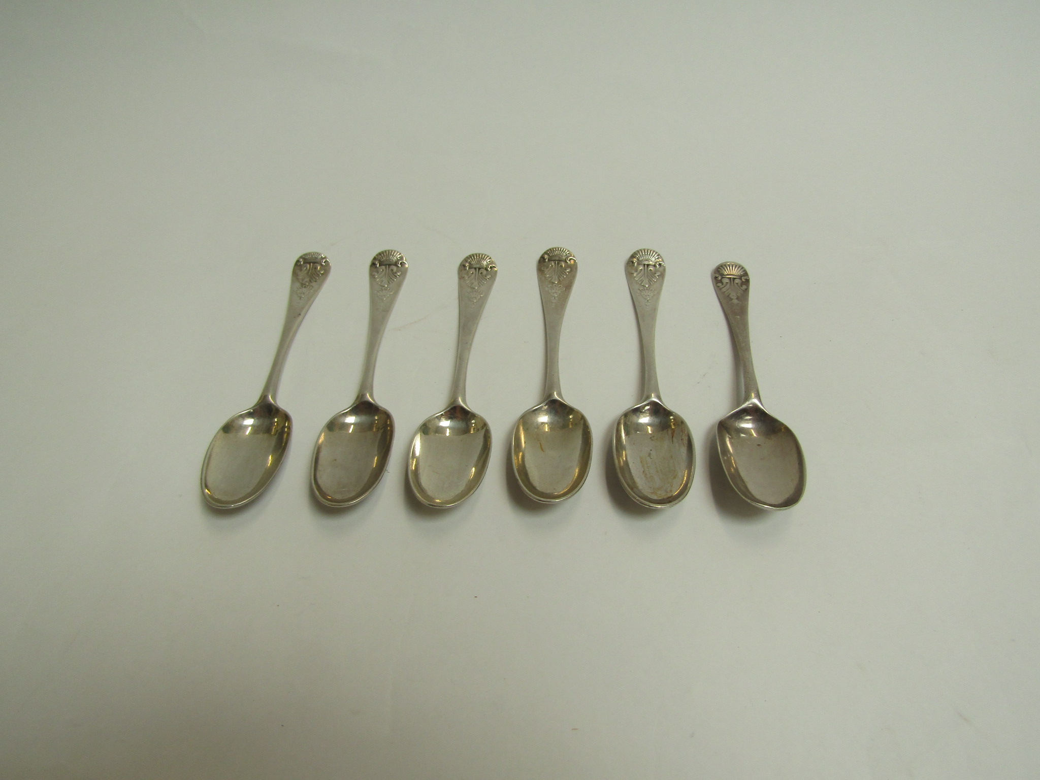 A set of six Georgian silver teaspoons, shell terminals, one with eagle engraved detail,