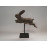 A carved wooden rabbit on pedestal stand,