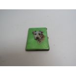 An early 20th Century cigarette case, the front cover decorated with a terrier.
