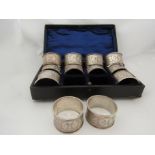 A set of twelve Miller Brothers (Charles Dew Miller) silver napkin rings, all over foliate design,