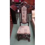 A Charles II style carved oak upright hall chair with turned stretchers and copper stud decoration,