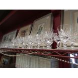 A large collection of crystal glass drinking glasses and water jug