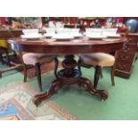 Circa 1840 a circular tilt top table on carved and turned column over scroll foot carved tripod
