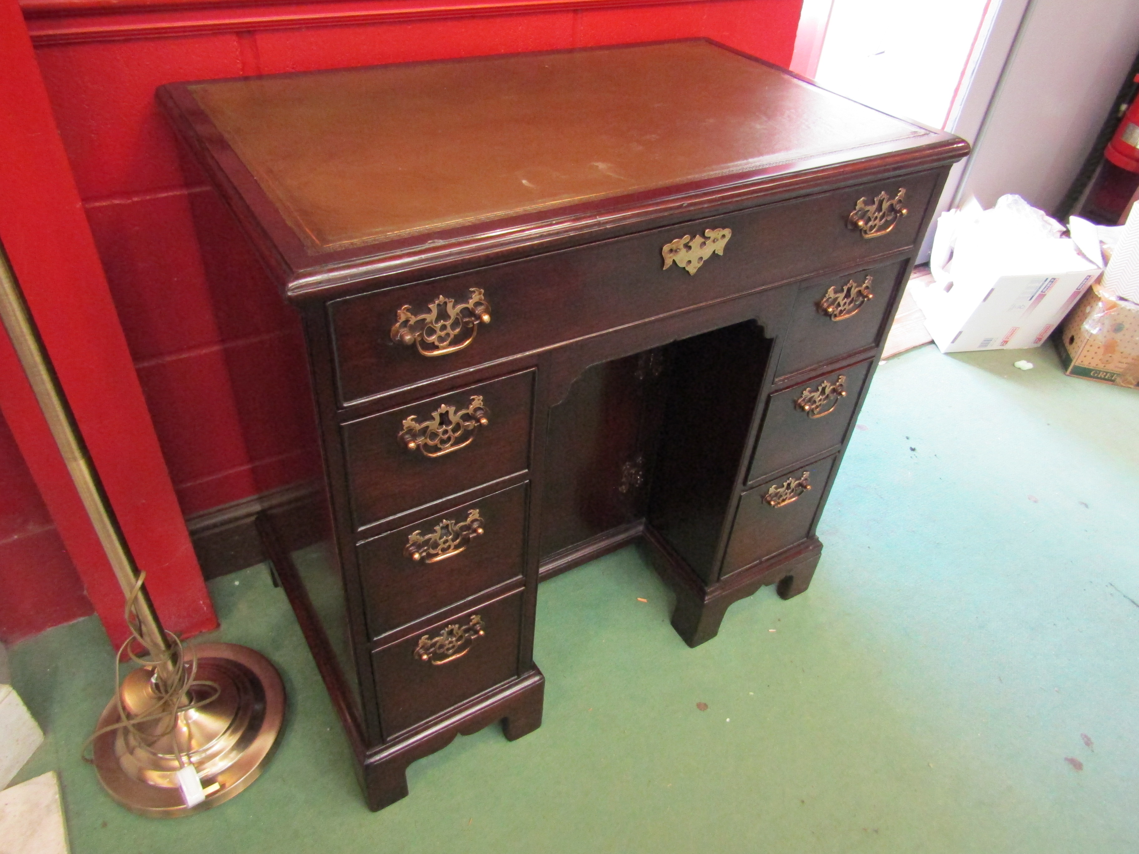 A George III flame mahogany twin pedestal desk the tooled leather insert over seven drawers and