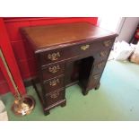 A George III flame mahogany twin pedestal desk the tooled leather insert over seven drawers and