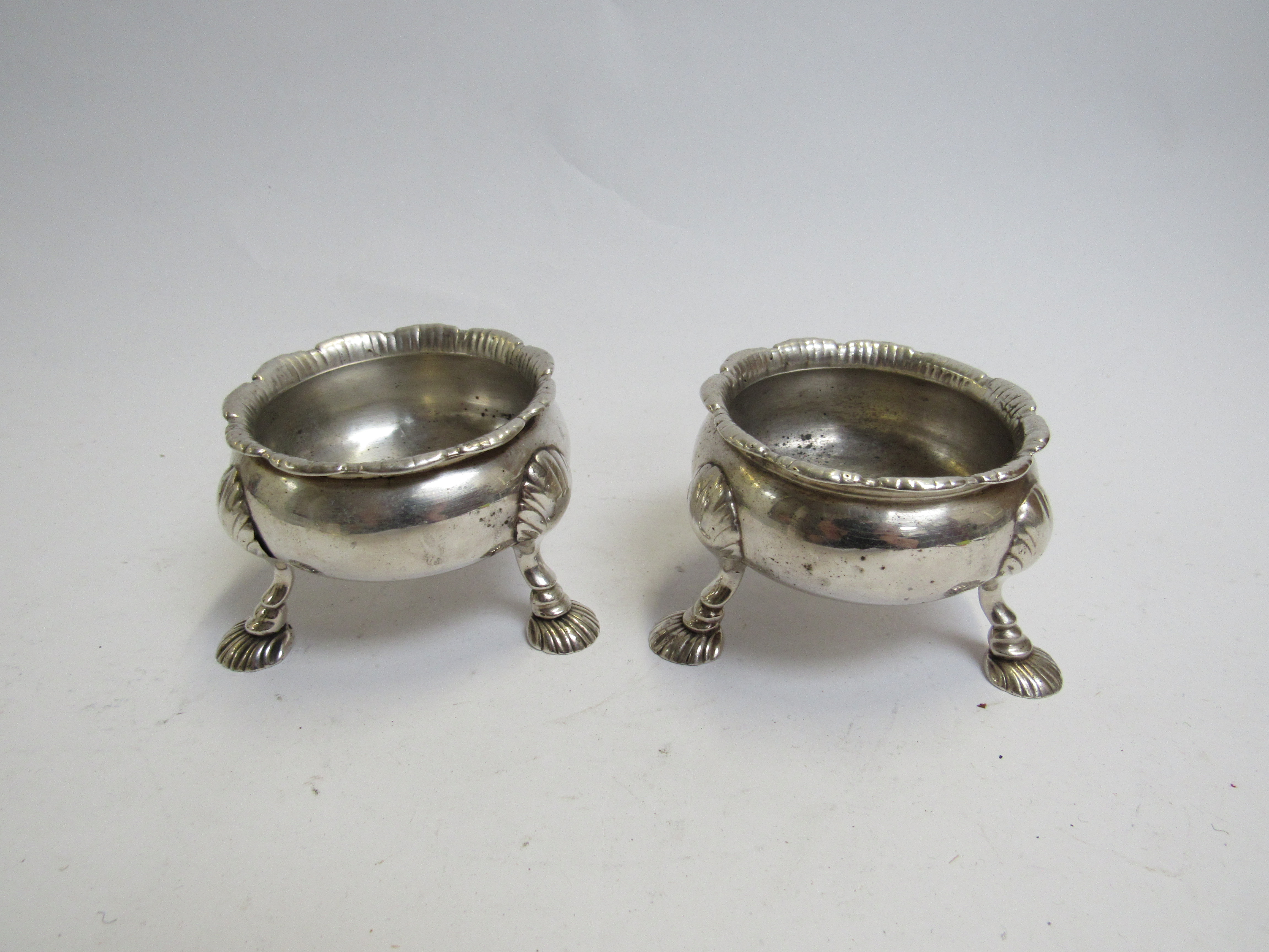 A pair of George III silver salts, fluted rim, shell footed base, marks rubbed,