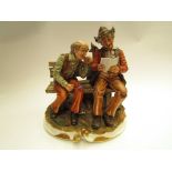 A Capodimonte figural scene depicting two seated gentlemen reading a paper (a/f)