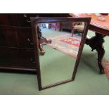 A mahogany framed wall hanging mirror with decorative gilt slip,