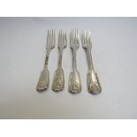 A matched set of four silver dessert forks with shell motif and vehicle engraved terminals,