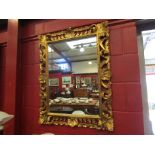 An ornate gilt framed wall mirror,