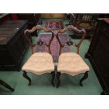 Circa 1840 a pair of carved rosewood chairs and serpentine front buttoned seat over cabriole legs,