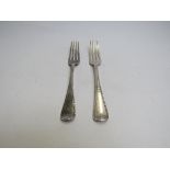 A pair of Chawner & Co (George William Adams) silver dinner forks with gadrooned border and bearded