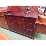 A 19th Century chest of three long drawers with brass swan neck handles over turned feet,