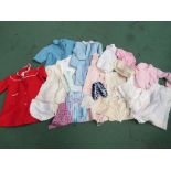 A box containing an assortment of children's wear including pure wool vests, towelling pants,