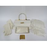 A 1960's wedding veil, a classic white handbag made by Eros of London,