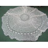 A white cotton circular crochet table cloth