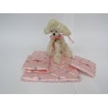 A kitsch miniature French poodle dog and a small quilted pouch