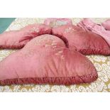 Three boudoir style dusky pink shaped cushions, a matching bed valance,
