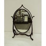 A George III 'Hepplewhite' mahogany swing-frame dressing table mirror with an oval plate and