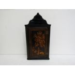 A George III Japanned hanging corner cupboard with tiered cresting over a single door richly