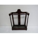 An early 19th century mahogany whip and stick stand with drip tray.