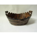 An oak and brass strapped oyster basket with raised pierced handles.