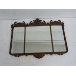 A George III style triple walnut framed mirror with fretwork surround and inset gesso decoration of