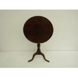 A Georgian style oak tilt-top wine table on tripod base Height 72cm Width 56cm Depth 56cm.