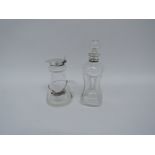 A conical glass whisky tot with hinged silver lid and star cut base by H.
