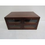 An Edwardian mahogany table-top haberdashery unit with four long glazed drawers arranged two over