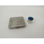 A silver cigarette case with bark effect cover and blue 'jewel' clasp stamped 800 together with a