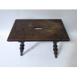 A late 18th/early 19th century fruitwood stool on turned legs,