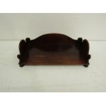 A mahogany table-top book stand with shaped galleried back and sides on bun feet. c.1840.