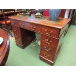 A Victorian mahogany twin pedestal desk, tooled leather top over nine drawer plinth base,